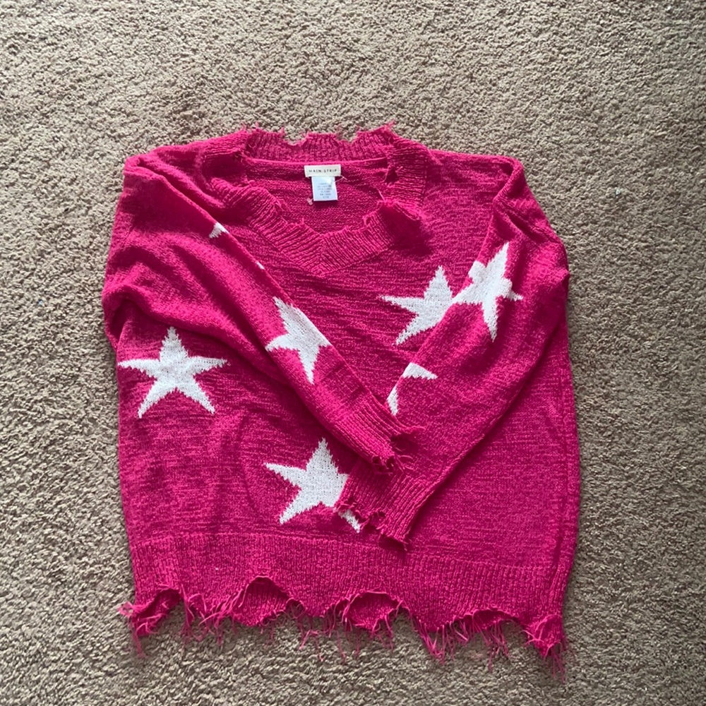 This sweater is a pink sweater with white stars!